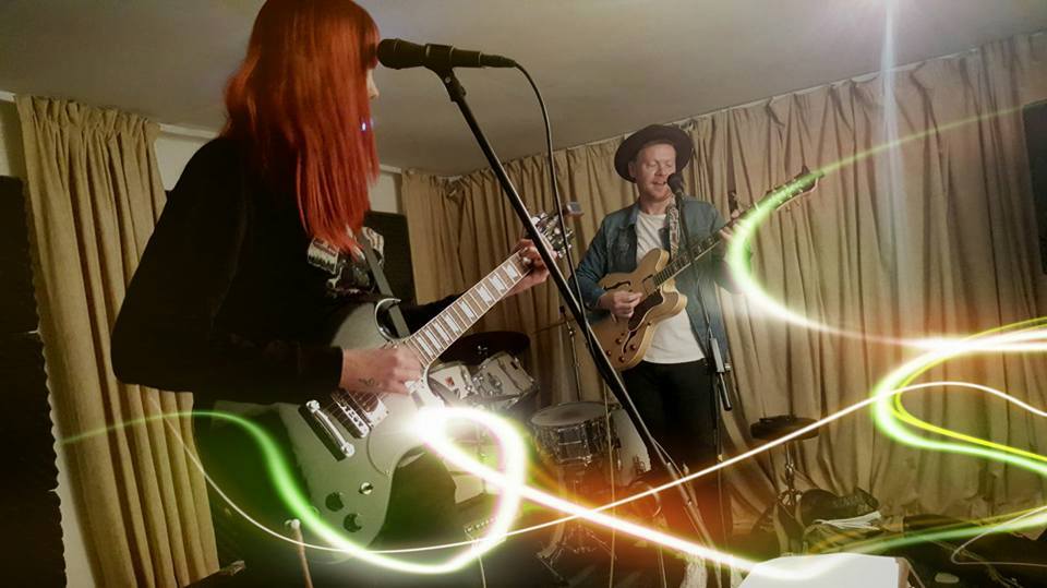 Duo recording their guitars and vocals