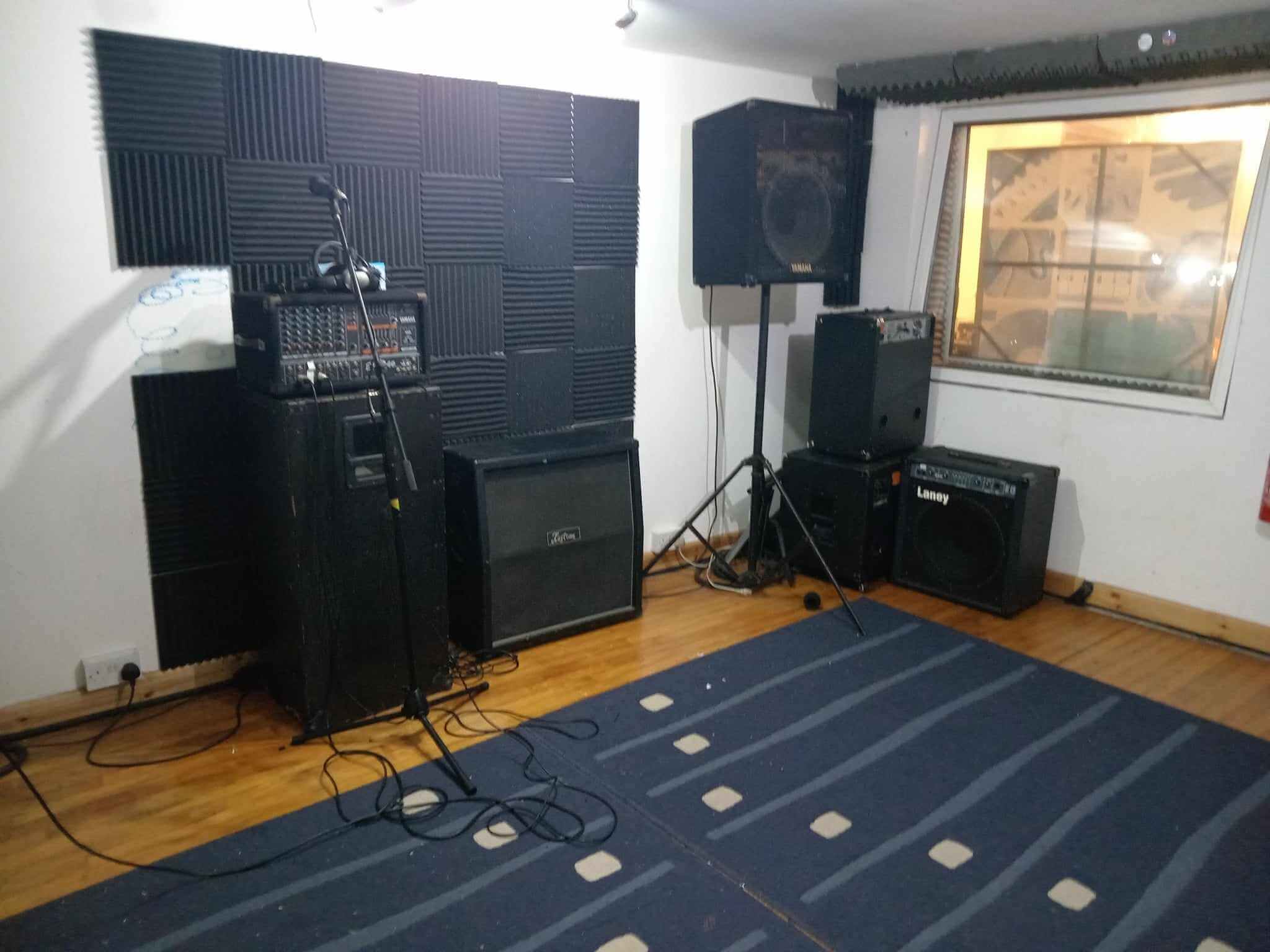 Rehearsal room with PA setup and bass rig